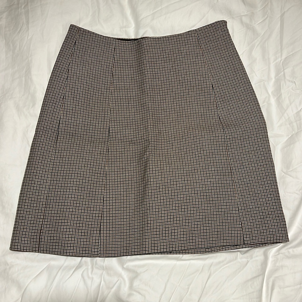 Tan/black/cream plaid skirt from Aritzia by Babaton.